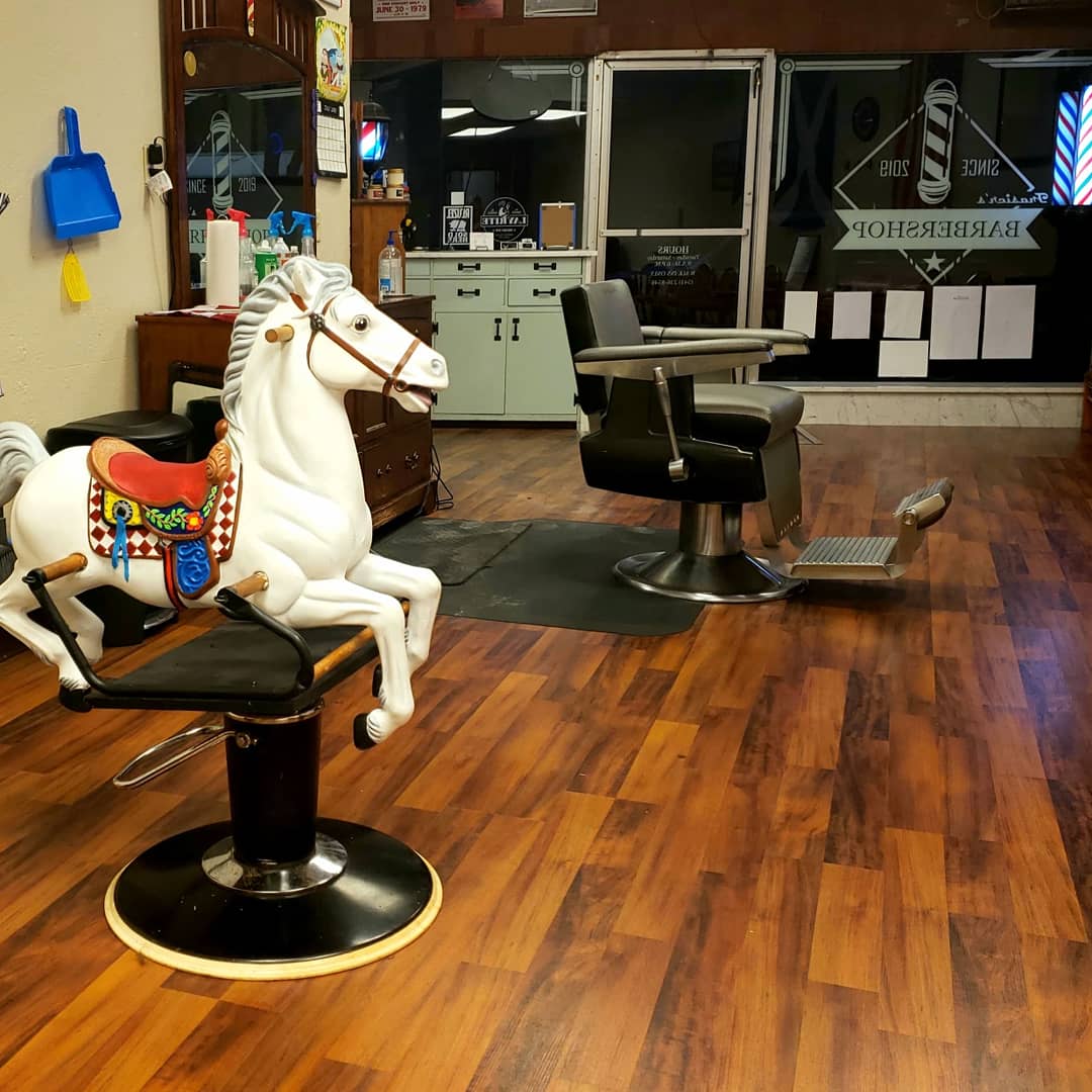 Vintage barber chairs and warm interior at Frasier's Barbershop