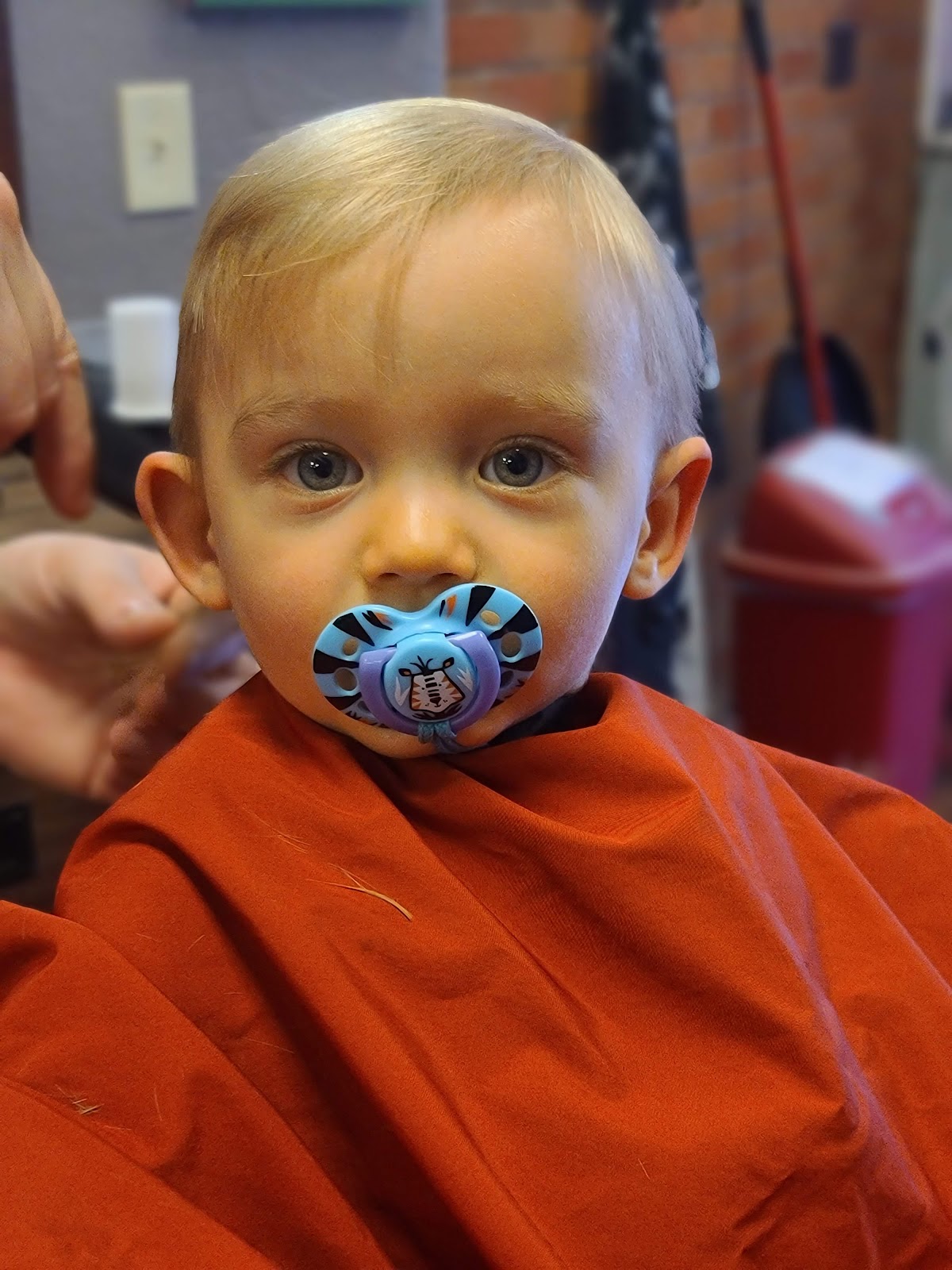 A baby's first haircut at Frasier's Barbershop