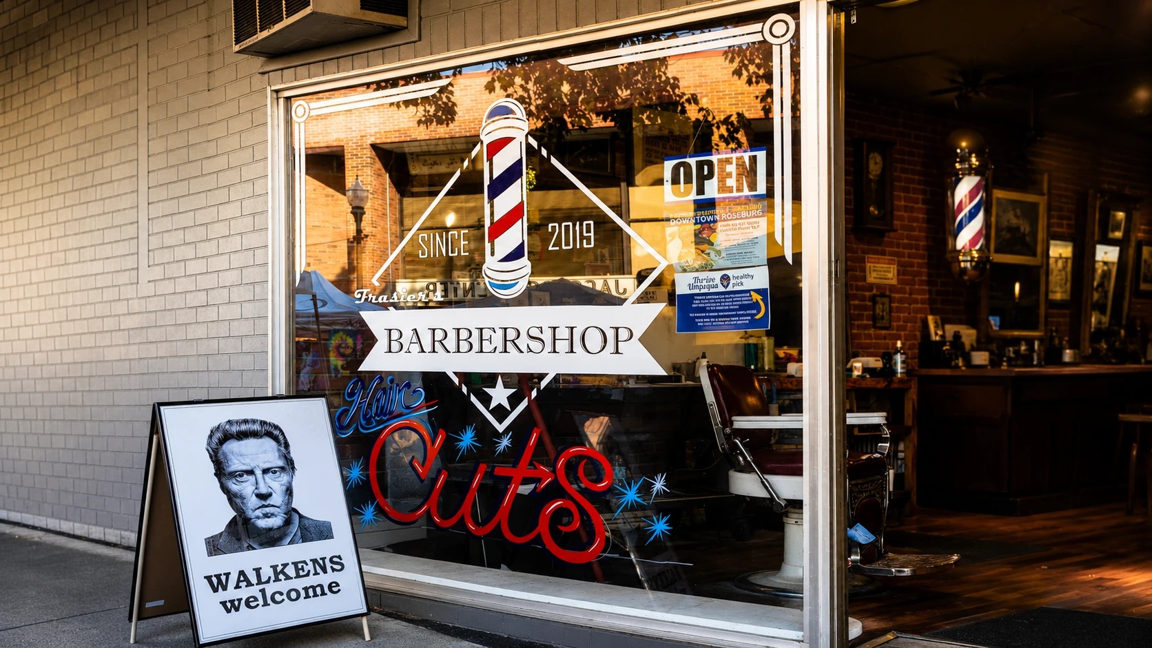 Frasier's Barbershop storefront in downtown Roseburg: the hand-painted barber-pole window, 'Since 2019', and the 'Walkens welcome' sandwich board